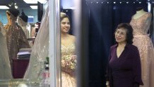 Latin Bridal owner Silvia Ferrusquia watches as customer Nina Hernandez tries on her quinceañera dress.