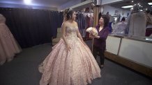 Latin Bridal owner Silvia Ferrusquia watches as customer Nina Hernandez tries on her quinceañera dress.