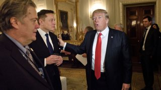 Trump advisor Steve Bannon (L) watches as President Donald Trump greets Elon Musk, SpaceX and Tesla CEO, before a policy and strategy forum with executives in the State Dining Room of the White House February 3, 2017 in Washington, DC.