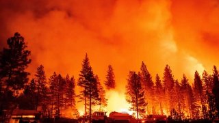 Water tender crews monitor a backfire during the Mosquito fire in Foresthill, an unincorporated area of Placer County, California on September 13, 2022.