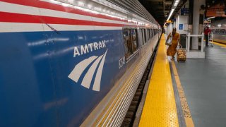 People walk to an Amtrak train in the Moynihan Train Hall on September 15, 2022 in New York City.