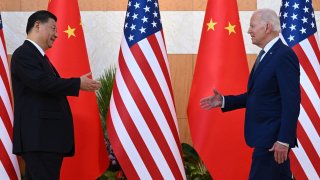 US President Joe Biden (R) and China’s President Xi Jinping (L) shake hands as they meet on the sidelines of the G20 Summit in Nusa Dua on the Indonesian resort island of Bali on November 14, 2022.