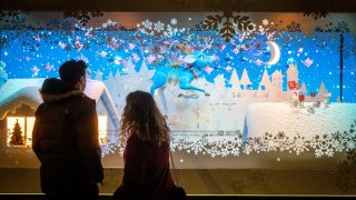 Pedestrians view the holiday windows at the Macy’s Inc. flagship department store in the Herald Square area of New York, U.S., on Thursday, Dec. 2, 2021.