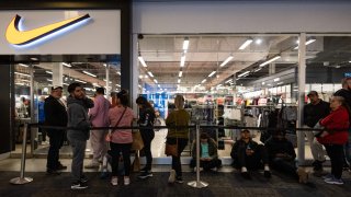 Black Friday shoppers wait to enter the Nike store at the Opry Mills Mall in Nashville, Tennessee, on November 25, 2022.