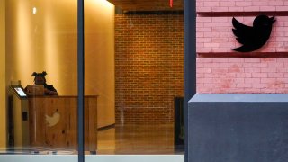 FILE – A receptionist works in the lobby of the building that houses the Twitter office in New York, Wednesday, Oct. 26, 2022.
