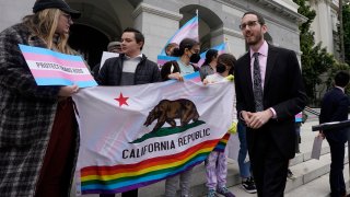 State Sen. Scott Wiener, D-San Francisco, right, prepares to announce his proposed measure to provide legal refuge to displaced transgender youth and their families during a news conference in Sacramento, Calif., Thursday, March 17, 2022. After the Nov. 8 election several newly elected lawmakers will join Wiener and other members of the LGBTQ caucus which will now make up 10% of the California state Legislature.