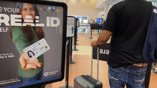 Homeland Security sign for REAL ID at entrance to passenger TSA security area, West Palm Beach, Florida.