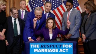 U.S. House Speaker Nancy Pelosi (D-CA) signs “The Respect for Marriage Act” alongside fellow members of Congress, during a bill enrollment ceremony on Capitol Hill, in Washington, U.S., December 8, 2022.