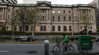 A cyclist travels past the Bank of Japan (BOJ) headquarters in Tokyo, Japan. Photographer: Noriko Hayashi/Bloomberg via Getty Images