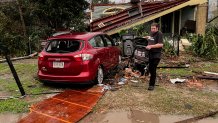 A house and car are seen damaged after a confirmed tornado on Friscoville Avenue in Arabi, La., in St. Bernard Parish, Wednesday, Dec. 14, 2022.