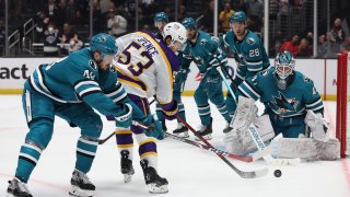 Jordan Spence #53 of the Los Angeles Kings skates for a rebound with Tomas Hertl #48 of the San Jose Sharks during a 3-2 overtime shootout Kings win at Crypto.com Arena on December 17, 2022 in Los Angeles, California. (Photo by Harry How/Getty Images)