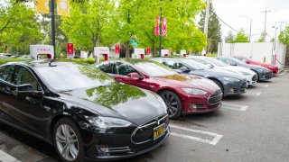 Row of Tesla Motors sedans charging at a supercharger station in the Silicon Valley town of Mountain View, California, April 7, 2017.