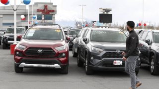 A salesman walks past used Toyota Motor vehicles at the Brent Brown Toyota dealership in Orem, Utah, on Monday, April 6, 2020.