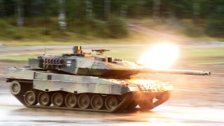 A Leopard 2 A6 fires during a maneuver of the German Forces Bundeswehr on September 18, 2013 in Munster, Germany.