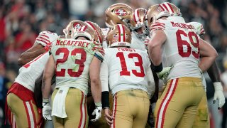 Brock Purdy #13 of the San Francisco 49ers huddles the offense.