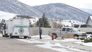 A police officer walks by a crime scene trailer that is sitting outside the home of Michael Haight on January 5, 2023 in Enoch, Utah