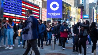 Monitors display Coinbase signage during the company’s initial public offering (IPO) at the Nasdaq MarketSite in New York, U.S., on Wednesday, April 14, 2021.