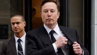Tesla CEO Elon Musk and his security detail depart the company’s local office in Washington, January 27, 2023.