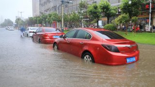 Cars are parked on the slow lane of a flooded Pingshan Road in Lianyungang city, East China’s Jiangsu Province, Aug. 23, 2021.