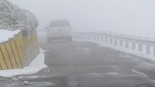 A car drive through snow during a storm at Lick Observatory in Mount Hamilton, California, US, on Thursday, Feb. 23, 2023. A sprawling winter storm is sweeping across the northern US this week, unleashing bitter cold and snow from California to Maine even as the Southeast sees record warmth. Photographer: David Paul Morris/Bloomberg via Getty Images