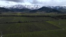 CALISTOGA, CALIFORNIA - FEBRUARY 24: In an aerial view, snow covers the hills surrounding the Napa Valley on February 24, 2023 in Calistoga, California. A large winter storm brought snow to lower elevations overnight in the Napa Valley. Much of California is being impacted by a cold winter storm that is bringing rain, wind a snow below 1,500 feet in many locations. (Photo by Justin Sullivan/Getty Images)