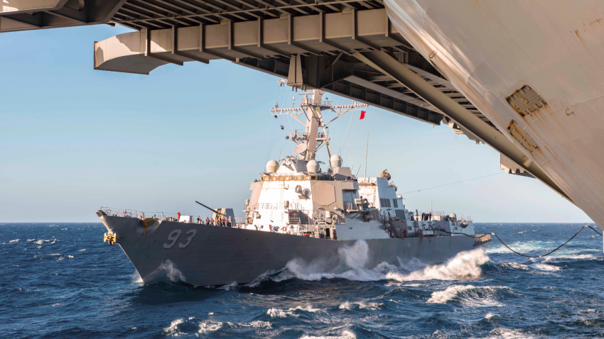 The USS Chung Hoon sails next to the USS Nimitz during a fueling in the South China Sea