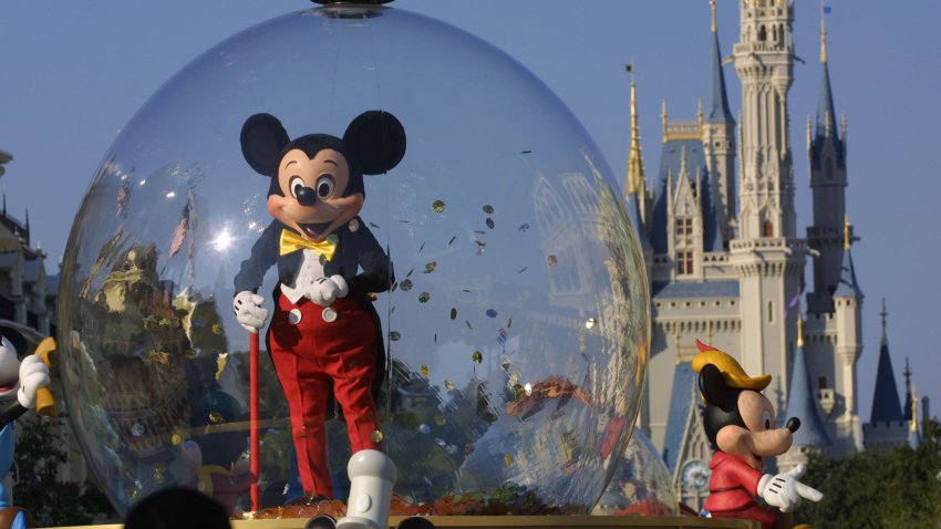 Mickey Mouse rides in a parade through Main Street, USA with Cinderella’s castle in the background at Disney World’s Magic Kingdom November 11, 2001 in Orlando, Florida. (Photo by Joe Raedle/Getty Images)