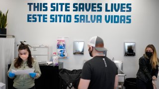 FILE – A sign on the wall reads “This site save lives” in Spanish and English at an overdose prevention center at OnPoint NYC in New York, Feb. 18, 2022.