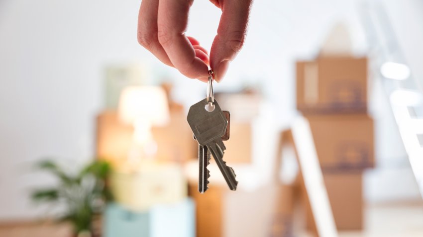 Close-up of woman holding house key in new home