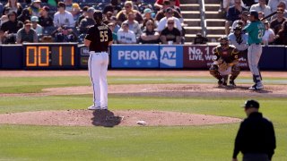 A pitch clock counts down as Jay Groome #55 of the San Diego Padres prepares to deliver a pitch to Eugenio Suarez #28 of the Seattle Mariners during the sixth inning in a spring training game at Peoria Stadium on February 24, 2023 in Peoria, Arizona.