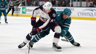 SAN JOSE, CALIFORNIA – MARCH 14: Kent Johnson #91 of the Columbus Blue Jackets and Derrick Pouliot #55 of the San Jose Sharks go for the puck in the third period at SAP Center on March 14, 2023 in San Jose, California. (Photo by Ezra Shaw/Getty Images)