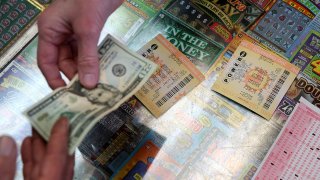 A customer buys Powerball tickets at Kavanagh Liquors on January 13, 2016 in San Lorenzo, California.