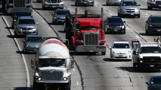 Cars, trucks, SUVs, and other vehicles drive in traffic on the 405 freeway through the Sepulveda Pass in Los Angeles, California, on August 25, 2022.