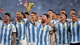 Lionel Messi of Argentina and teammates celebrate with the FIFA World Cup trophy during the World Champions’ celebrations after an international friendly match between Argentina and Curaçao at Estadio Unico Madre de Ciudades on March 28, 2023 in Santiago del Estero, Argentina.