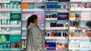 A woman passes by the BeautySpace NK display at the Walmart Supercenter