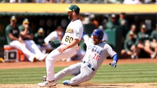 Patrick Wisdom #16 of the Chicago Cubs slides into home plate.