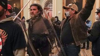 FILE - Rioters, including Dominic Pezzola, center with police shield, are confronted by U.S. Capitol Police officers outside the Senate Chamber inside the Capitol, Jan. 6, 2021, in Washington.