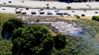 Crews contain a brush fire off northbound Interstate 280 at Highway 92 in San Mateo County. (May 26, 2023)