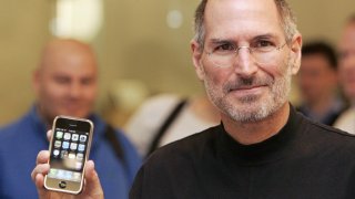 FILE - Steve Jobs shows off the first iPhone.