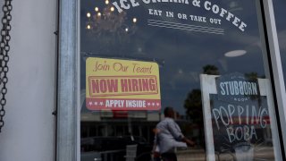 A ‘Now Hiring’ sign posted outside of a restaurant looking to hire workers on May 05, 2023 in Miami, Florida.