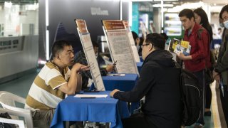 People look for jobs at a fair in Shanghai, China, on May 20, 2023.