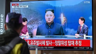 A man watches a television screen showing a news broadcast with file footage of North Korea’s leader Kim Jong Un, at the Seoul Railway Station in Seoul on May 31, 2023.