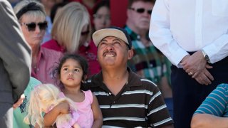 Mass shooting survivor Wilson Garcia looks up to the sky during a vigil for his son Daniel Enrique Laso, 9, Sunday, April 30, 2023, in Cleveland, Texas. Garcia’s son and wife were killed in the shooting Friday night. The search for a Texas man who allegedly shot his neighbors after they asked him to stop firing off rounds in his yard stretched into a second day Sunday, with authorities saying the man could be anywhere by now. The suspect fled after the shooting Friday night that left five people dead. (AP Photo/David J. Phillip)