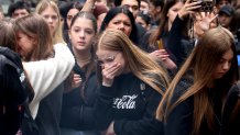 School children mourn the victims near the Vladislav Ribnikar school in Belgrade, Serbia, Thursday, May 4, 2023. 