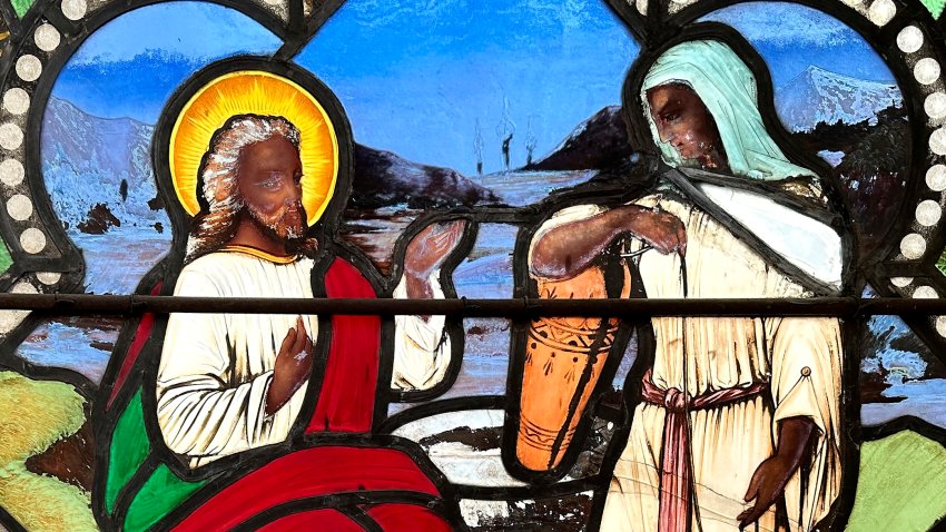 A detail of a nearly 150-year-old stained-glass window depicts Christ speaking to a Samaritan woman, in the now-closed St. Mark’s Episcopal church, Monday, May 1, 2023, in Warren, R.I. The nearly 150-year-old stained-glass window from the Rhode Island church that depicts Christ and three New Testament women with dark skin has stirred up questions about race and the place of women in both biblical and 19th century society. (AP Photo/Mark Pratt)