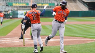 Yordan Alvarez #44 (R) of the Houston Astros celebrates with teammate Alex Bregman #2 after hitting a solo home run in the first inning against the Oakland Athletics at RingCentral Coliseum on May 28, 2023 in Oakland, California. (Photo by Kavin Mistry/Getty Images)