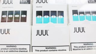 Juul packages are seen on a shelf at Empire Smoke Shop on December 07, 2022 in the Flatbush neighborhood of Brooklyn borough in New York City.