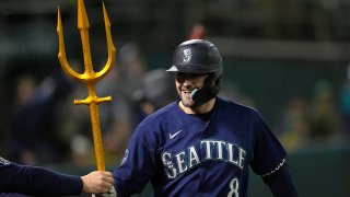 AJ Pollock #8 of the Seattle Mariners celebrates after hitting a solo home run to tie the game 2-2 against the Oakland Athletics in the top of the ninth inning at RingCentral Coliseum on May 03, 2023 in Oakland, California. The Mariners won the game 7-2. (Photo by Thearon W. Henderson/Getty Images)