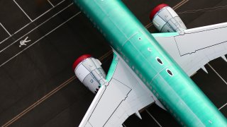 An aerial view of the engines and fuselage of an unpainted Boeing 737 MAX airplane parked in storage at King County International Airport-Boeing Field in Seattle, Washington, June 1, 2022.