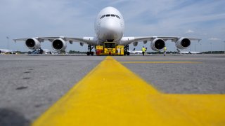 A Lufthansa Airbus A380 aircraft stands at the gate at the airport prior to departure for Boston. The world’s largest passenger aircraft is taking off again after three years on regular scheduled service from Munich to Boston.
